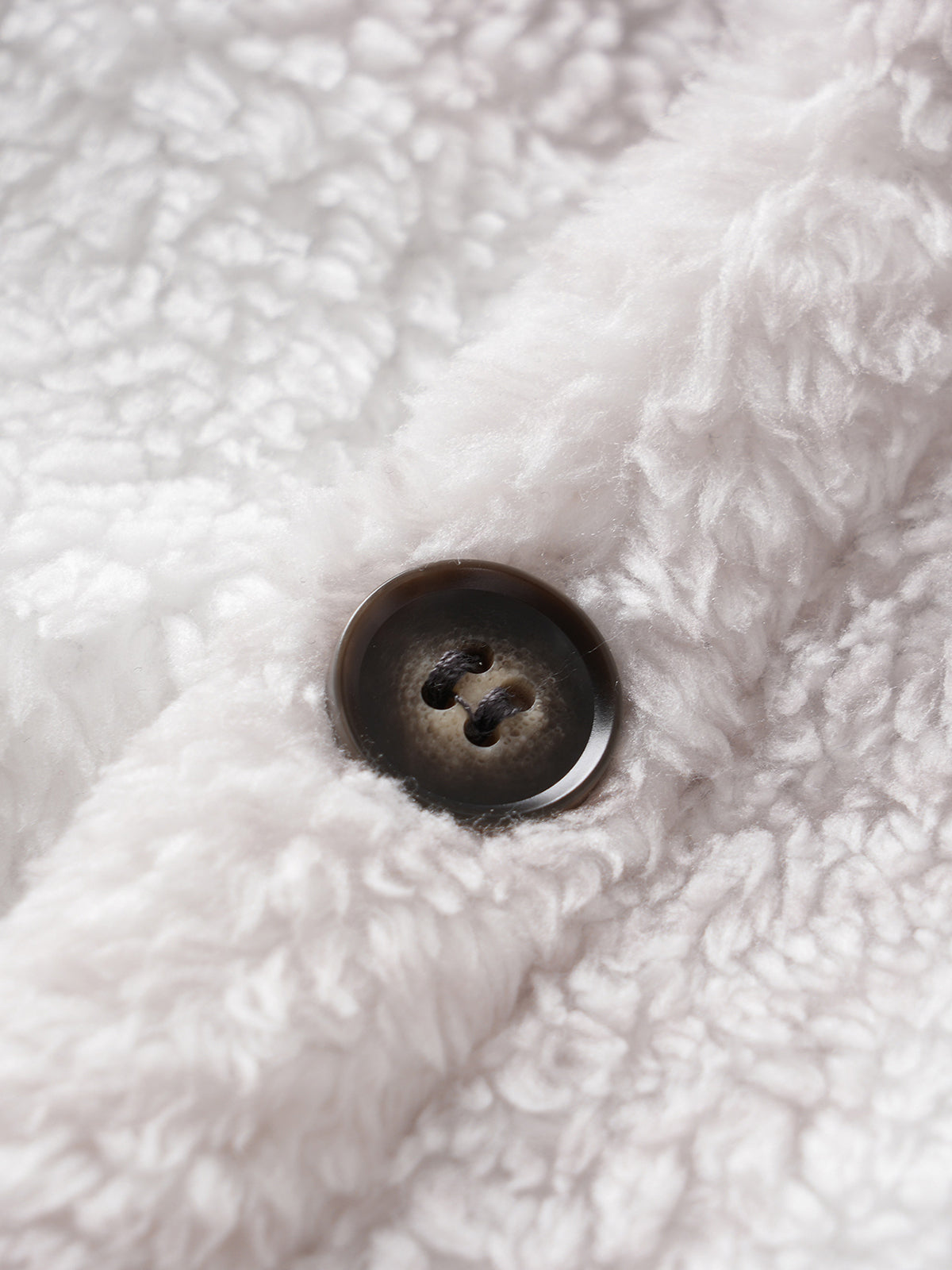 Classic men's plaid jacket with plush faux fur shoulder details, single pocket, buttons, and collar lapel