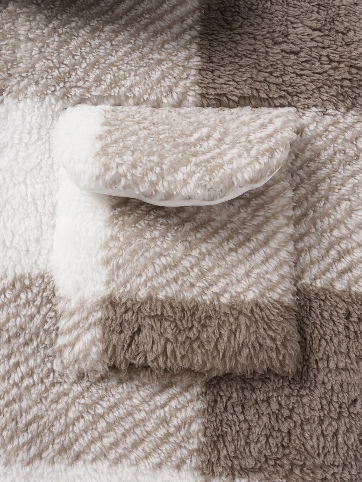 Classic men's plaid jacket with plush faux fur shoulder details, single pocket, buttons, and collar lapel