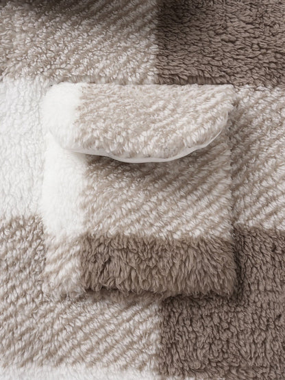 Classic men's plaid jacket with plush faux fur shoulder details, single pocket, buttons, and collar lapel