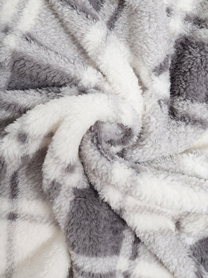 Classic men's plaid jacket with plush faux fur shoulder details, single pocket, buttons, and collar lapel