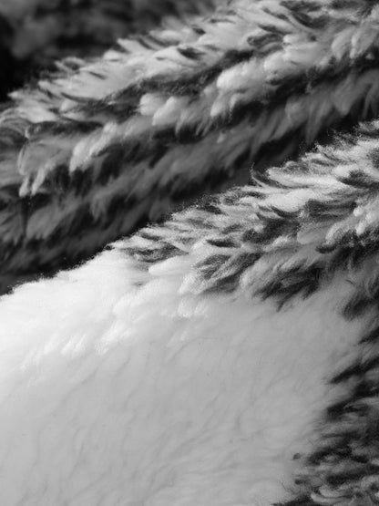 Classic men's plaid jacket with plush faux fur shoulder details, single pocket, buttons, and collar lapel