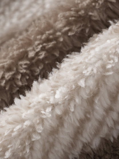 Classic men's plaid jacket with plush faux fur shoulder details, single pocket, buttons, and collar lapel