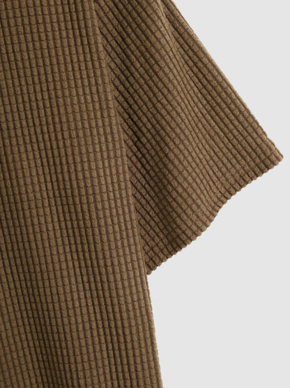 Men's polo shirt with a plain plaid pattern, textured collar, and short sleeves